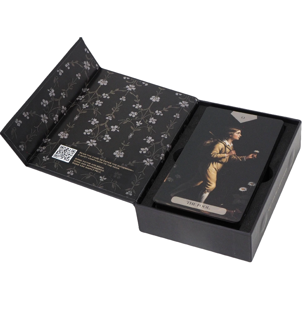 Baroque-inspired tarot cards from The Divine Artisan Tarot with dark green packaging