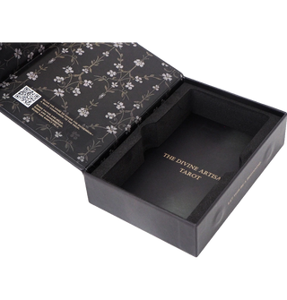Close-up view of The Divine Artisan Tarot box and cards with elegant dark artwork